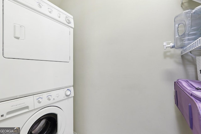 laundry room featuring stacked washer / drying machine