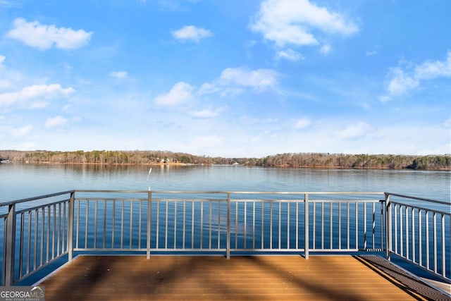 view of dock featuring a water view and a balcony