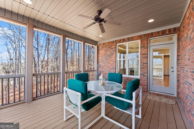 sunroom with wood ceiling and ceiling fan