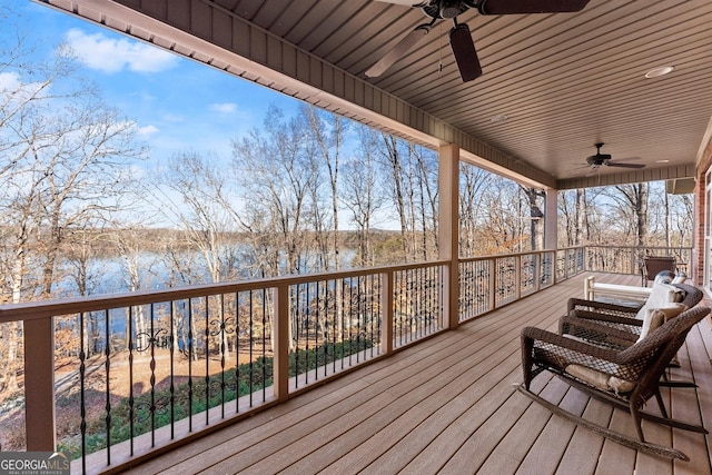 wooden deck featuring ceiling fan and a water view