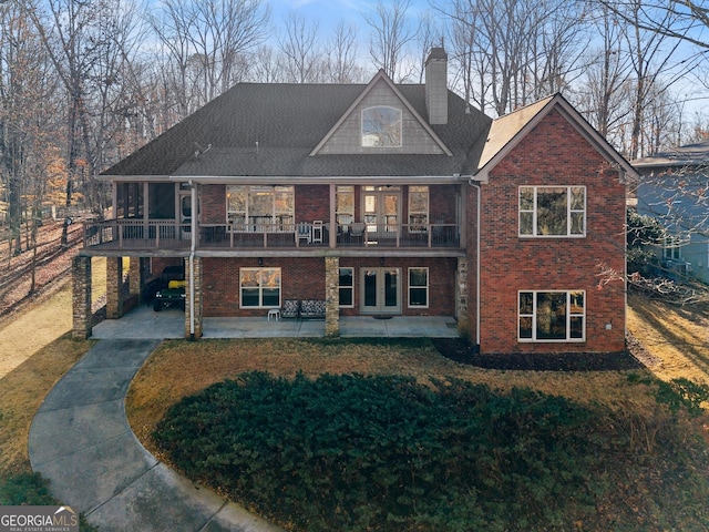 rear view of property with a patio area and a lawn