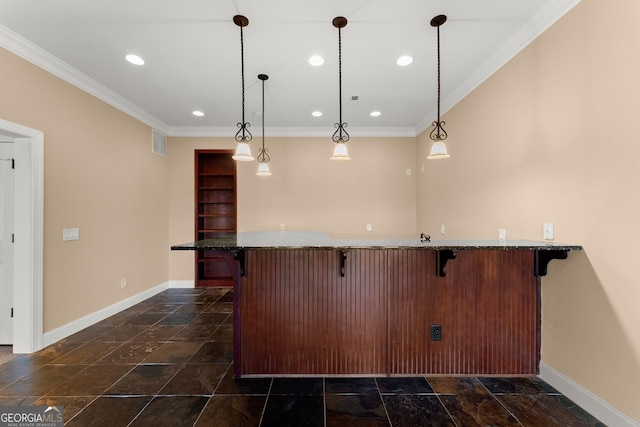 kitchen featuring pendant lighting, a breakfast bar, a center island, ornamental molding, and stone countertops