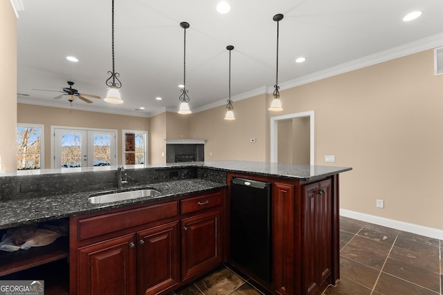 kitchen with french doors, ornamental molding, dark stone counters, and sink