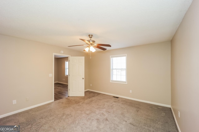 empty room with carpet floors and ceiling fan