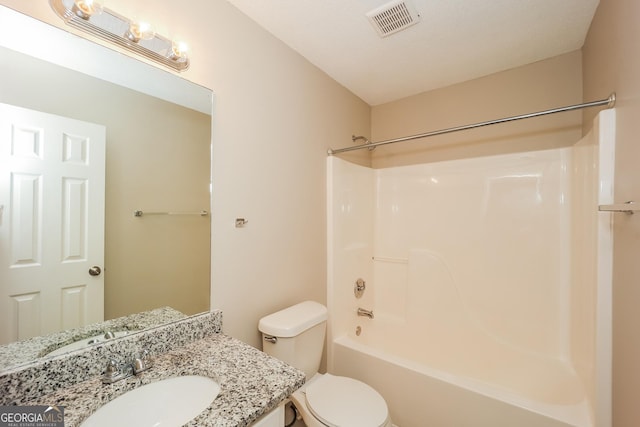 full bathroom featuring bathing tub / shower combination, vanity, and toilet