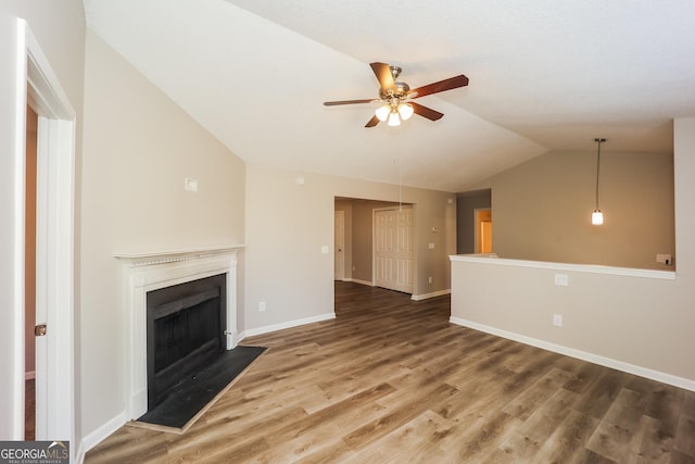 unfurnished living room featuring hardwood / wood-style floors, vaulted ceiling, and ceiling fan