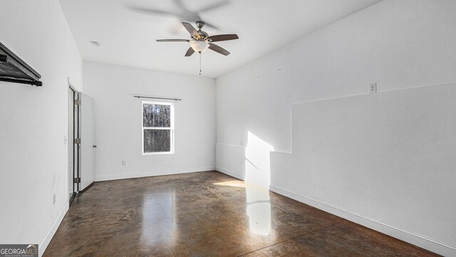 unfurnished room with ceiling fan and dark hardwood / wood-style flooring