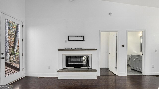 kitchen featuring decorative light fixtures, appliances with stainless steel finishes, dark hardwood / wood-style floors, white cabinets, and backsplash