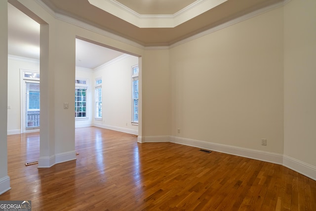 unfurnished room featuring hardwood / wood-style floors and ornamental molding