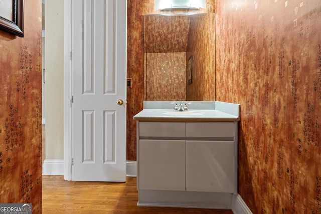 bathroom featuring vanity and hardwood / wood-style flooring