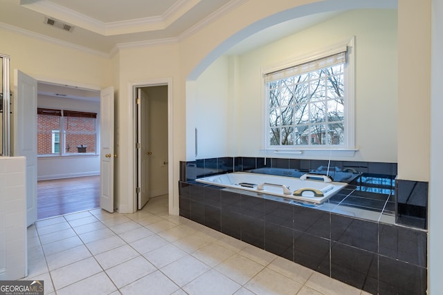 bathroom with crown molding, a tray ceiling, and tile patterned flooring