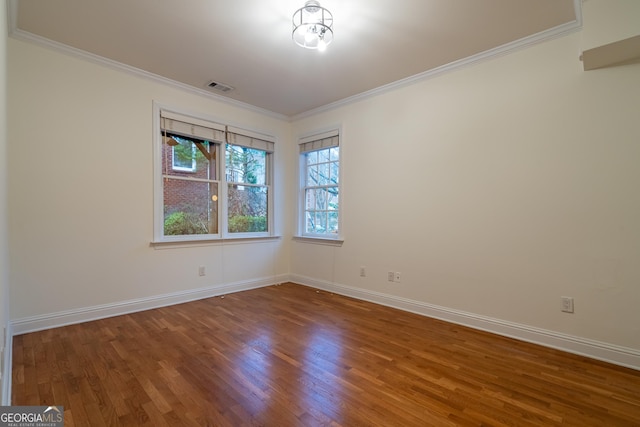 unfurnished room featuring crown molding and hardwood / wood-style flooring