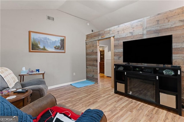 living room with lofted ceiling and light hardwood / wood-style floors