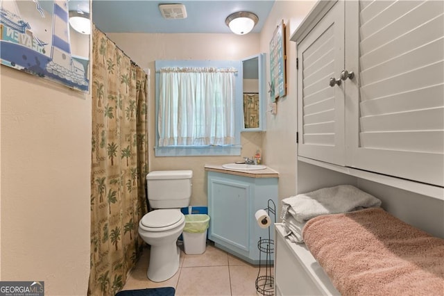 bathroom featuring tile patterned flooring, vanity, and toilet