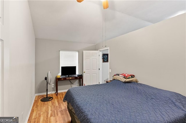 bedroom featuring ceiling fan, lofted ceiling, and hardwood / wood-style floors