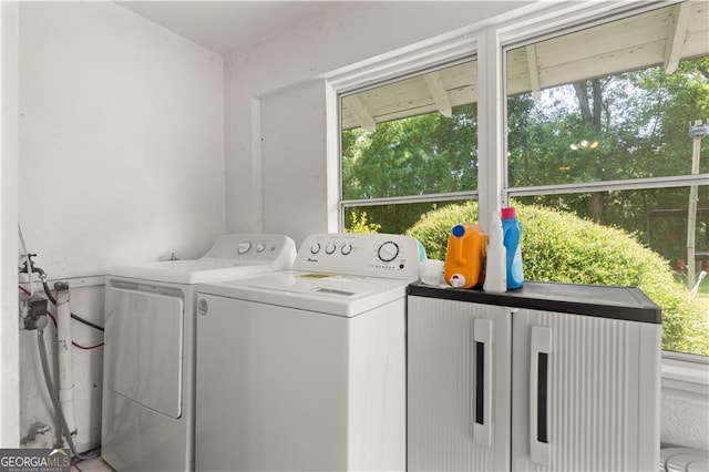 clothes washing area with washing machine and clothes dryer