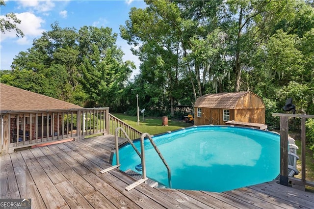 view of pool featuring a storage shed and a wooden deck