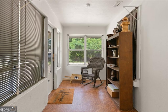 living area with parquet flooring