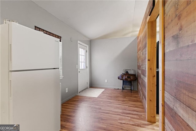 entryway featuring lofted ceiling and light hardwood / wood-style floors