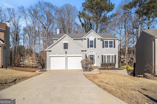 front facade featuring a garage and a front yard