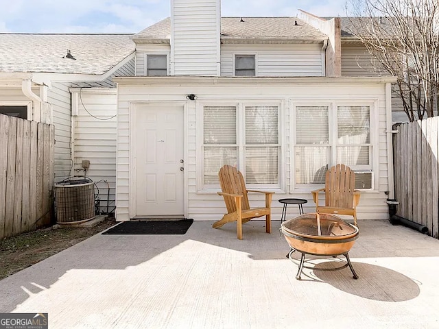 exterior space featuring an outdoor fire pit, a patio area, and central air condition unit