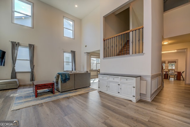 living room with plenty of natural light, light hardwood / wood-style flooring, and ornate columns