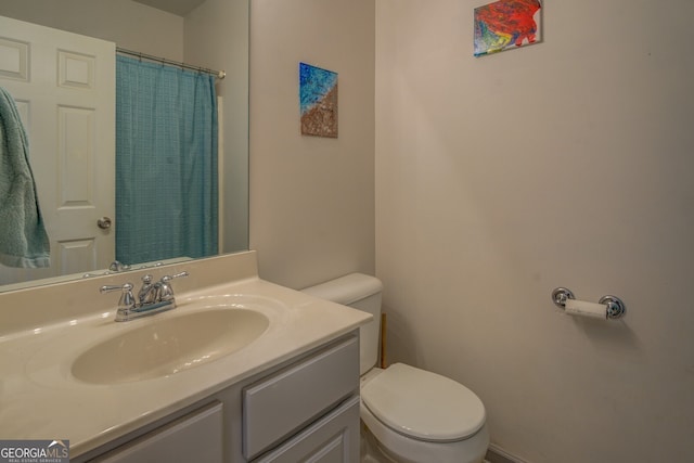 bathroom featuring vanity, toilet, and a shower with shower curtain