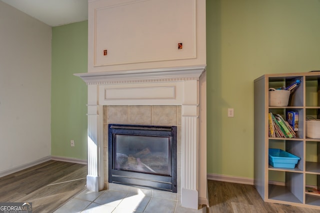 interior details featuring hardwood / wood-style flooring and a fireplace