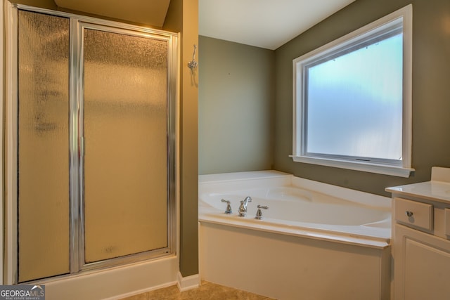 bathroom featuring vanity and shower with separate bathtub