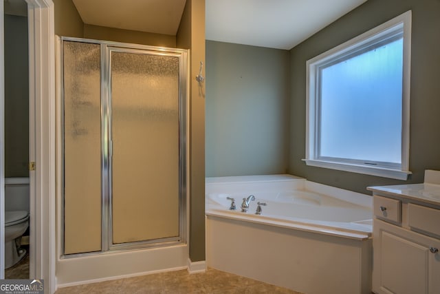 full bathroom featuring independent shower and bath, vanity, tile patterned flooring, and toilet