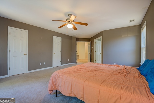 bedroom with ceiling fan and light colored carpet