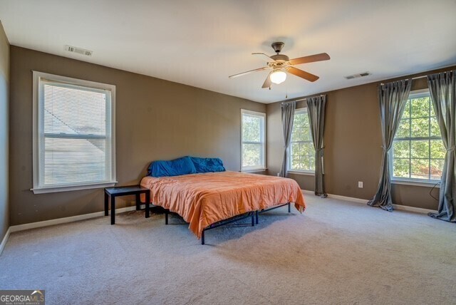 carpeted bedroom with ceiling fan