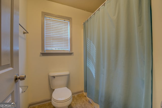 bathroom with tile patterned floors and toilet