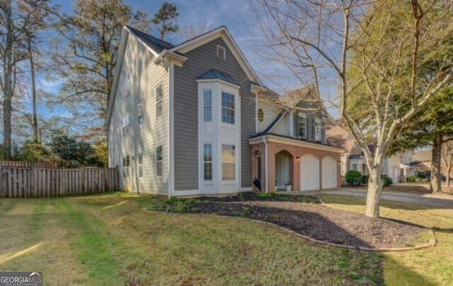 view of front facade with a garage and a front lawn