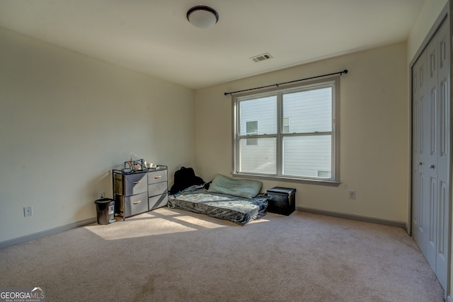 carpeted bedroom featuring a closet