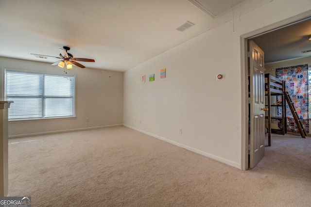 unfurnished room with ceiling fan and light colored carpet