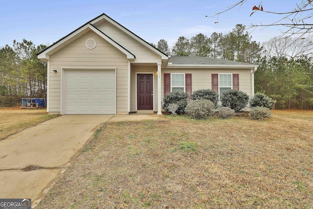 view of front of home featuring a garage and a front yard