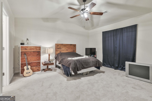 carpeted bedroom featuring ceiling fan, visible vents, and vaulted ceiling