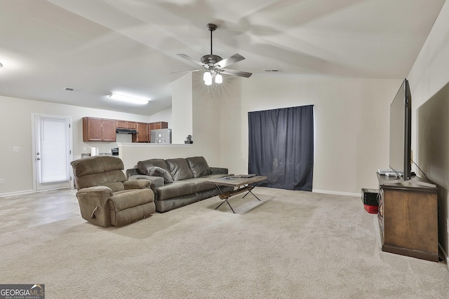 carpeted living room with vaulted ceiling and ceiling fan