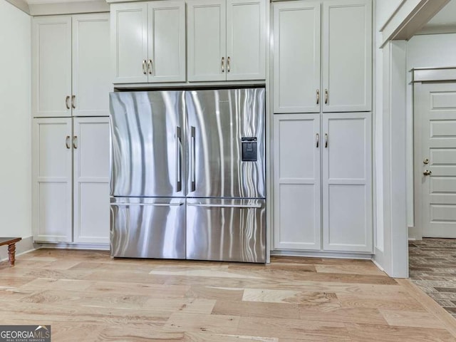 kitchen featuring light hardwood / wood-style floors, white cabinets, and stainless steel refrigerator with ice dispenser