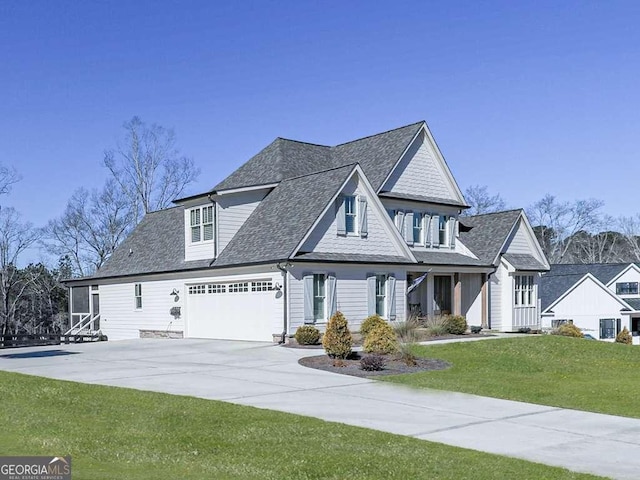 view of front of property featuring a garage and a front lawn