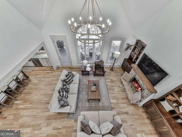 living room featuring a high ceiling and light wood-type flooring