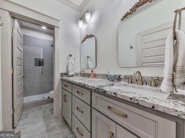 bathroom featuring vanity, a shower with shower door, and toilet