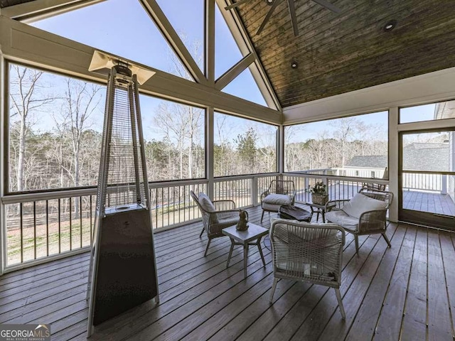 sunroom with lofted ceiling and a healthy amount of sunlight