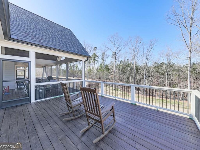 wooden deck featuring a sunroom