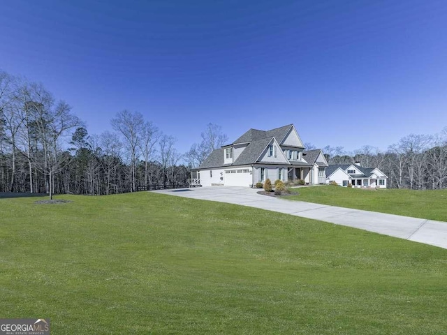 view of front of property featuring a garage and a front lawn