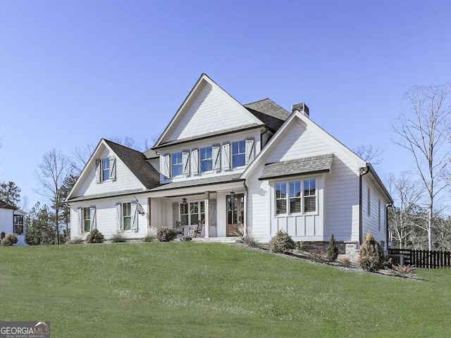 view of front of house with a porch and a front yard