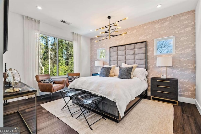 bedroom featuring dark hardwood / wood-style floors and a chandelier