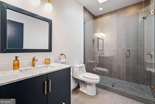 bathroom featuring vanity, tile patterned flooring, toilet, and walk in shower