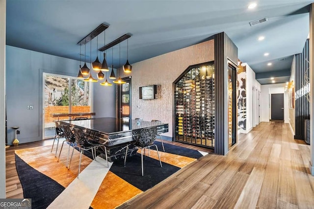 wine area with light hardwood / wood-style flooring